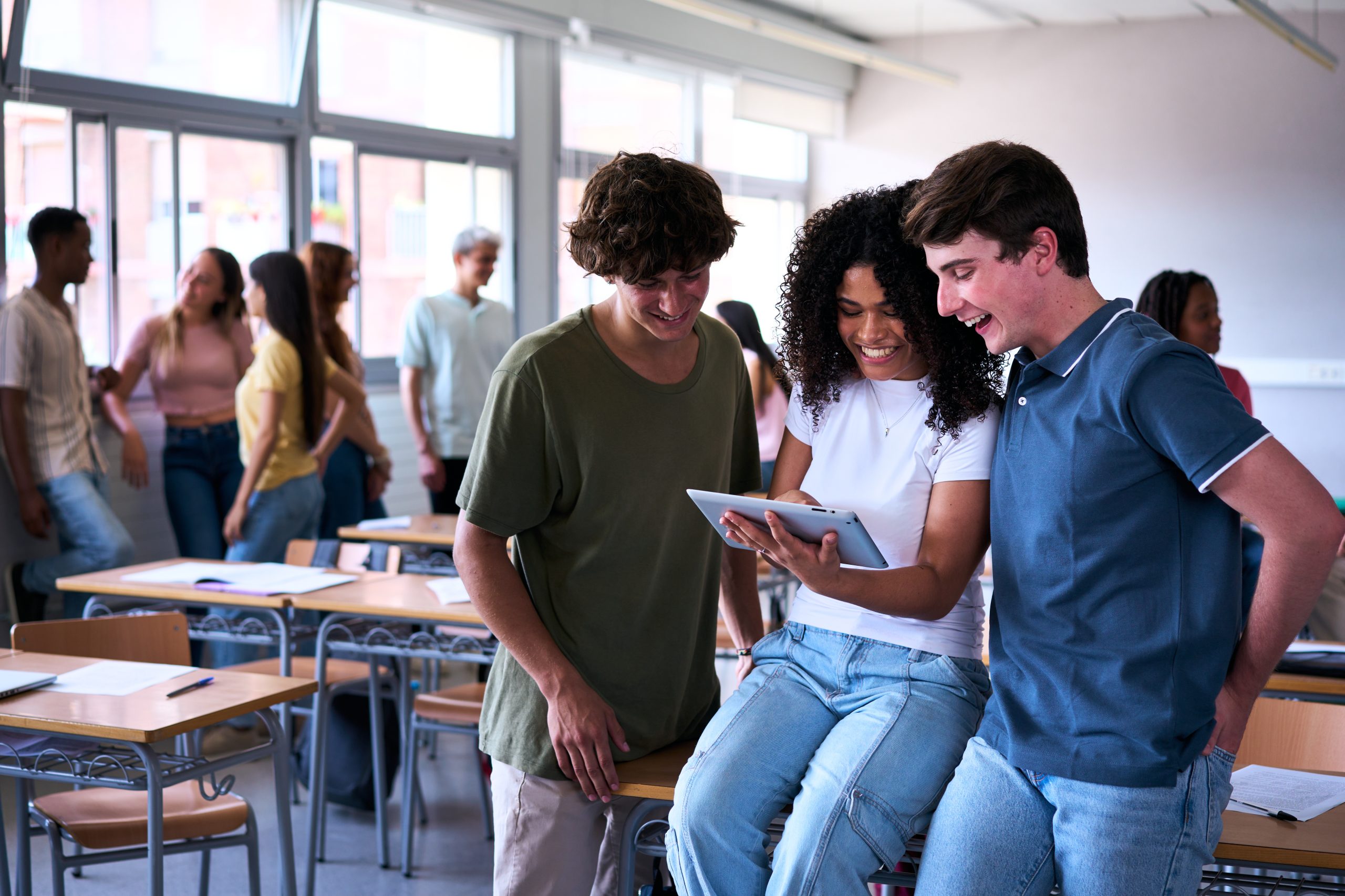 Group of students around a digital tablet