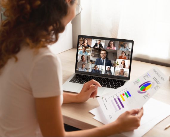 Woman looking at Emergenetics Profile and computer screen during Associate Certification