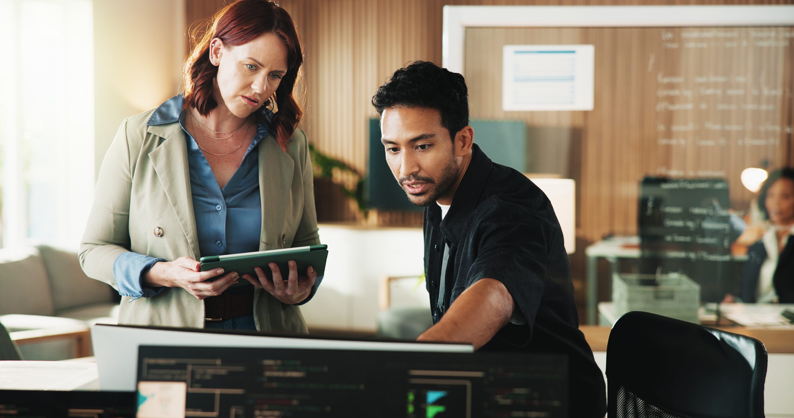 Tablet, programmer and computer with business people in office for web developer, research or feedback. Code review, software engineer and database with employees in tech startup for it - AI collaboration.